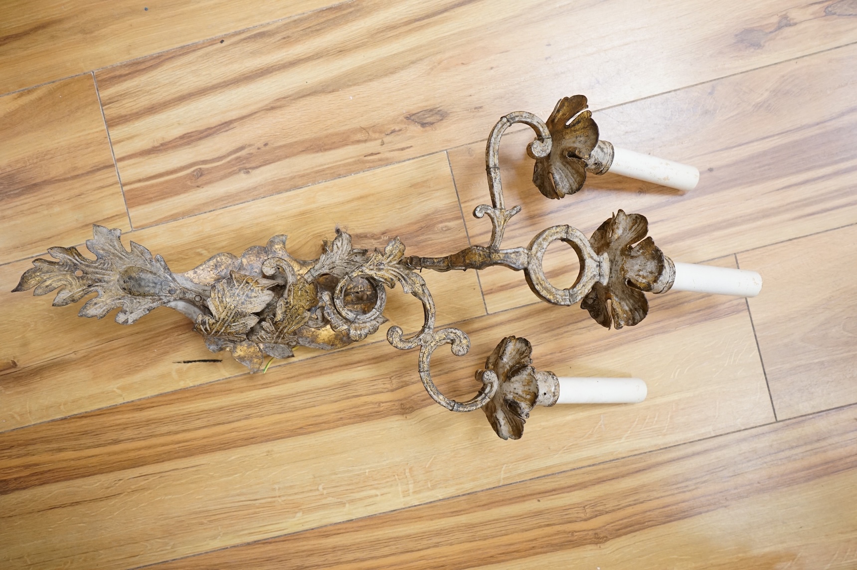 Four French decorative metal two branch wall sconces, 63cm high including faux candle attachments, including silk shades